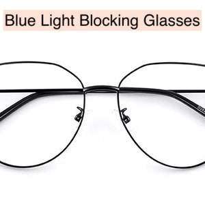 May include: Black metal frame blue light blocking glasses with a geometric shape.