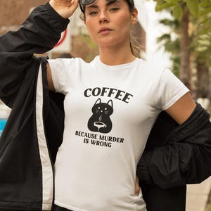 May include: White t-shirt with a black cat graphic and the text "COFFEE BECAUSE MURDER IS WRONG".