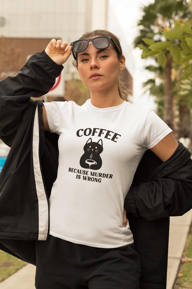 May include: White t-shirt with a black cat graphic and the text "COFFEE BECAUSE MURDER IS WRONG".