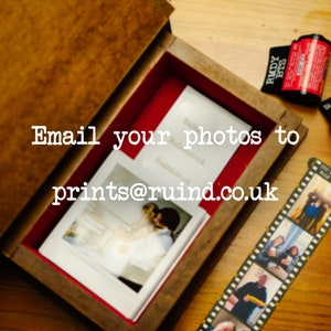 May include: A wooden box with a red felt lining and a white card with the text "Email your photos to prints@ruind.co.uk".