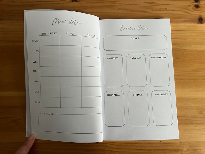 May include: A blank meal planner and exercise planner with sections for each day of the week. The meal planner has sections for breakfast, lunch, and dinner. The exercise planner has a section for goals and a section for each day of the week.