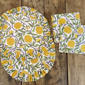 Padded quilted round table mat with frill and napkins, set of two · Pure cotton block print handmade and handprinted in India · Yellow cones