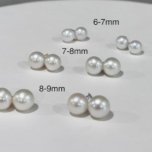 May include: Three pairs of white spherical pearl stud earrings arranged in rows. The pairs are labeled with size ranges: 6-7mm, 7-8mm, and 8-9mm. Each pair consists of two round, lustrous white pearls with visible metal earring posts attached to the back.