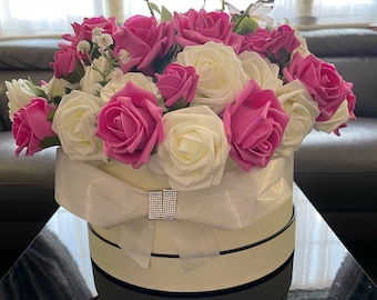 Vintage cream coloured hat box,hand arranged with pink & white foam Tea roses with diamanté  bow. Special for Mothers day/ Valentines day.