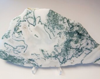 May include: A large, white agate slab with green moss agate inclusions. The agate has a natural, rough surface and is a beautiful example of this type of stone.