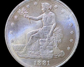 May include: A silver dollar coin with a seated Liberty figure holding a branch of olive leaves and a sheaf of wheat. The coin has a beaded edge and the inscription "In God We Trust" and the date "1881".