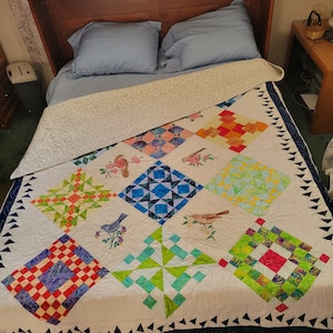 Embroidered birds and hummingbird quilt