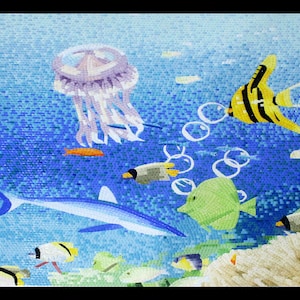 May include: A colorful mosaic tile mural depicting an underwater scene with a blue shark, a jellyfish, and various tropical fish swimming among coral and bubbles.