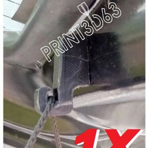 May include: A black plastic car window latch with a rope attached. The latch is labelled "PRINT3D63" and "1X".