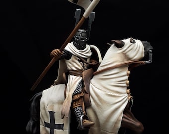 May include: A miniature figurine of a knight on horseback, holding a flag with a black cross. The knight is clad in white and chainmail armor. The horse is draped in white fabric. The base is a textured, rocky surface. The text "Chivalry Miniatures 3D" is visible.
