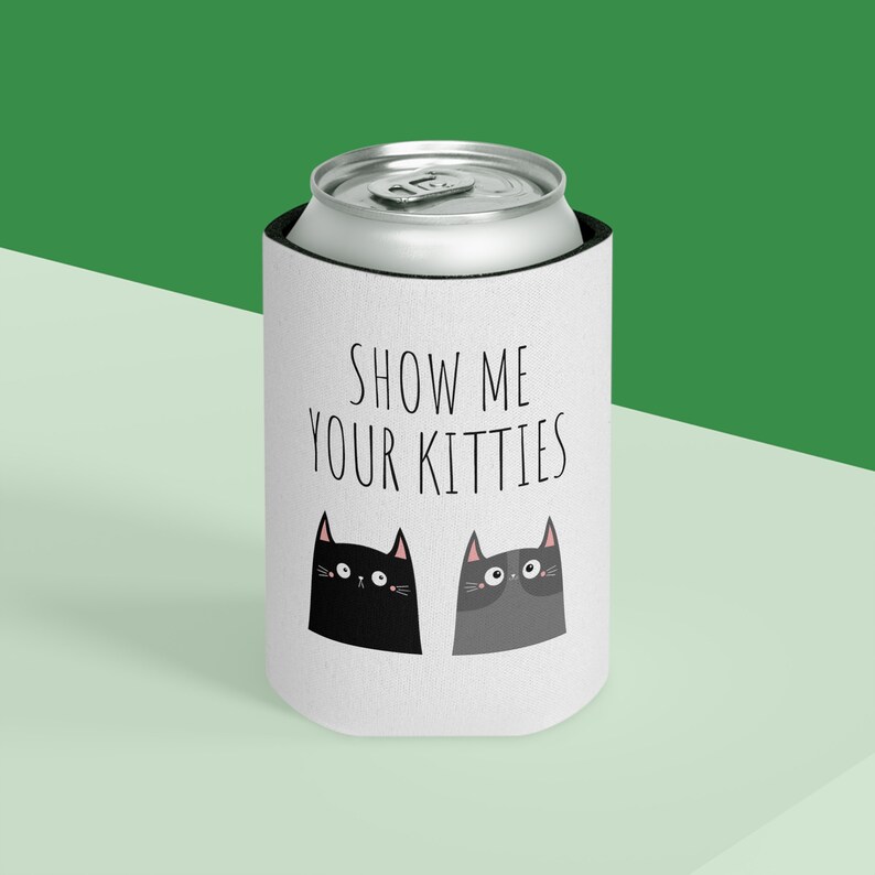 May include: White can cooler with black text that says "Show me your kitties". Two black and gray cartoon cats with pink noses are on the cooler.
