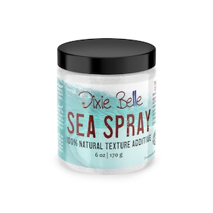 May include: A white jar with a black lid containing a white powder. The label reads "Dixie Belle Sea Spray 100% Natural Texture Additive 6 oz | 170 g".