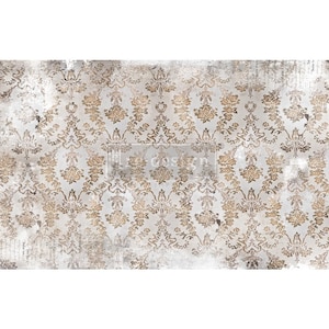 May include: A distressed, vintage-style decorative paper with a repeating floral damask pattern in gold and cream. The design features ornate, symmetrical floral motifs and a weathered, textured appearance. The word "design" is visible in the center.