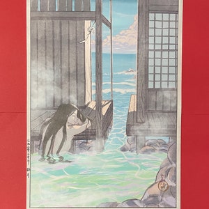 May include: A Japanese woodblock print showing a woman taking a bath outdoors, with a view of the sea. The bath is surrounded by rocks and steam. The woman has long black hair and is wearing a white cloth. The print is in shades of blue, green, and brown.