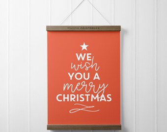 May include: A red printable poster with white text that reads "We wish you a merry Christmas" with a star and a stylized Christmas tree design.