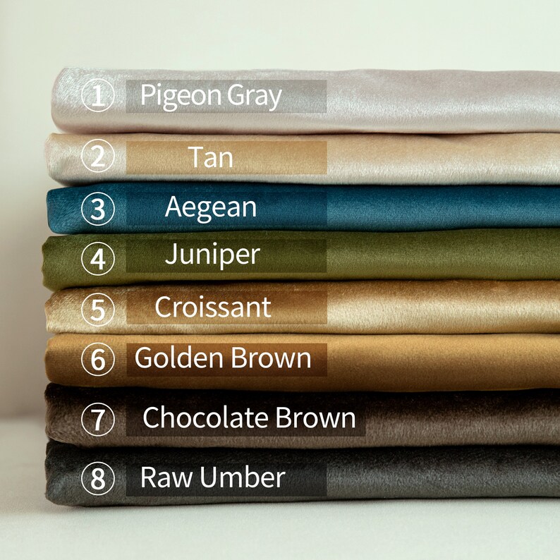 May include: A stack of eight fabric swatches in various colors, including Pigeon Gray, Tan, Aegean, Juniper, Croissant, Golden Brown, Chocolate Brown, and Raw Umber. Each swatch is labeled with its color name.
