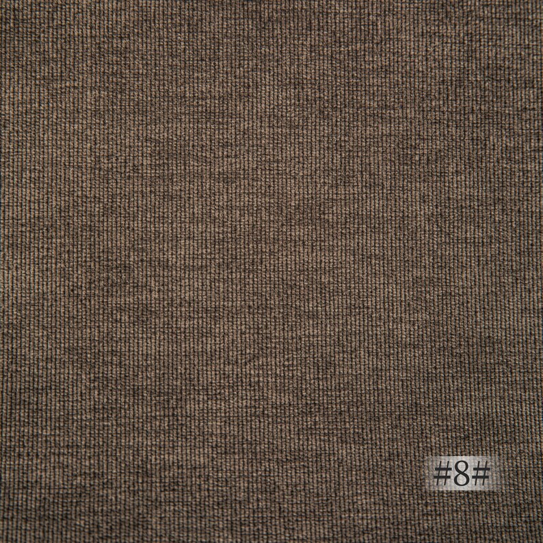 May include: Close-up of a brown textured fabric with a subtle woven pattern. The fabric has a slightly rough feel and a slightly darker brown color. #8# is printed in the bottom right corner of the image.