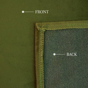 May include: Close-up of a green fabric with a stitched border. The front of the fabric is a solid, matte green, while the back is a darker shade. The word "FRONT" and "BACK" are labeled on the image.