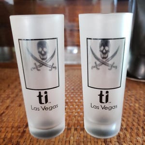 Pair/Set of 2 Vintage 2oz Skull and Crossbones Pirate Shot Glasses from Treasure Island/TI, Las Vegas, 4 inches tall. New Old Stock NOS