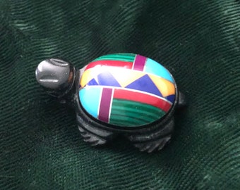 Pingente de tartaruga Zuni com múltiplas pedras preciosas incrustadas, prata de lei e ônix preto.
