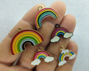 May include: Assortment of rainbow charm pendants with gold-tone metal. Some charms feature clouds and a unicorn.
