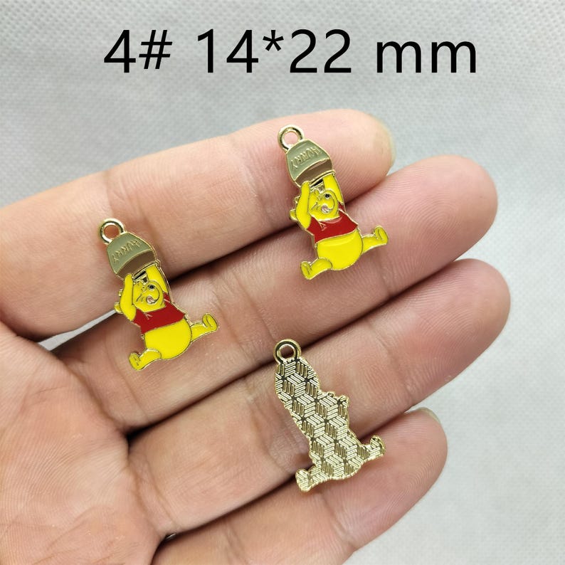 May include: Three yellow, red, and brown Winnie the Pooh charms with gold-colored jump rings. The charms are 14 x 22 mm in size. One charm is a gold-colored, patterned bear. The text "4# 14*22 mm" is at the top of the image.