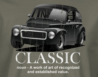 May include: A green t-shirt with a black and white illustration of a classic car. The text "CLASSIC" is printed below the car, along with the definition: "noun - A work of art of recognized and established value."