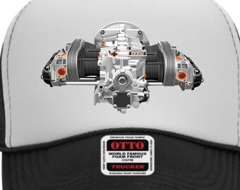 May include: A black and white trucker hat with a detailed illustration of an aircraft engine on the front. The hat features a white front panel with the engine graphic, a black brim, and a black mesh back. The hat has a snap closure and a small patch that reads "OTTO".
