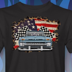 May include: A black t-shirt with a blue vintage pickup truck in front of a distressed American flag with checkered racing flags.