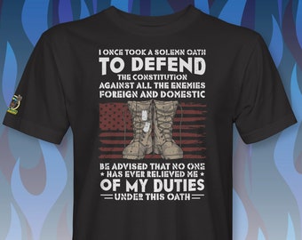 May include: Black t-shirt with a graphic of a pair of military boots and an American flag. The text reads "I once took a solemn oath to defend the constitution against all the enemies foreign and domestic. Be advised that no one has ever relieved me of my duties under this oath."