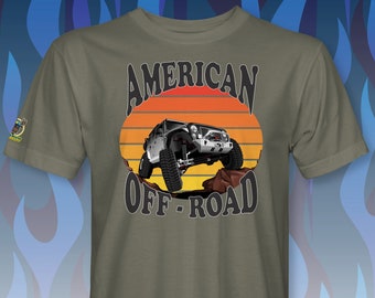 May include: A green t-shirt with a vintage-style graphic of a Jeep driving off-road. The graphic features a sunset background and the text "AMERICAN OFF-ROAD".