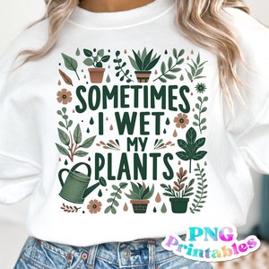 May include: White sweatshirt with a green, brown, and white graphic design featuring plants and the text "Sometimes I Wet My Plants".