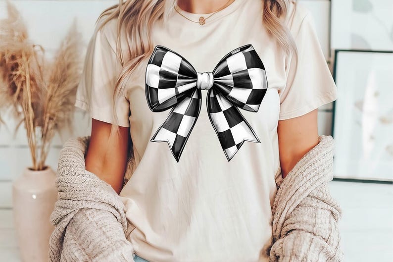 May include: A white t-shirt with a black and white checkered bow design.
