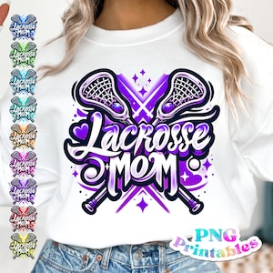 May include: A white sweatshirt with a purple and white graphic design of two lacrosse sticks crossed with the text "Lacrosse Mom" in a purple and white font. The graphic also includes a heart and stars.
