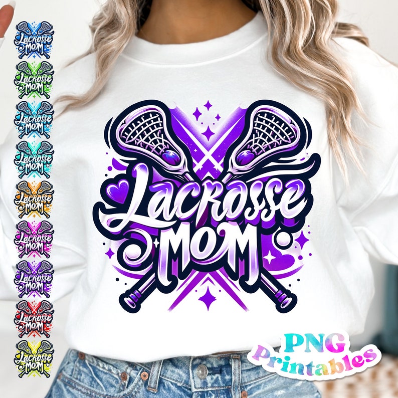 May include: A white sweatshirt with a purple and white graphic design of two lacrosse sticks crossed with the text "Lacrosse Mom" in a purple and white font. The graphic also includes a heart and stars.