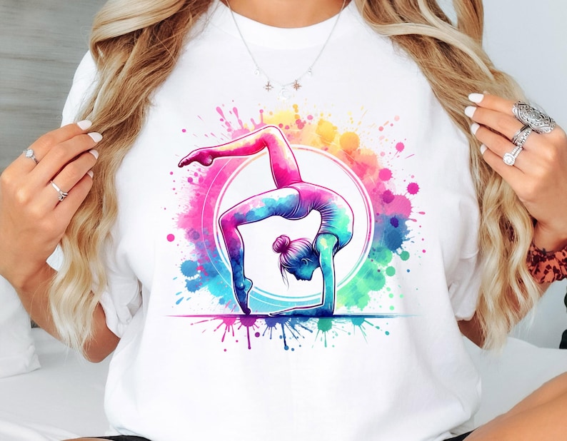 May include: A white t-shirt with a colorful watercolor design of a gymnast performing a handstand on a balance beam.