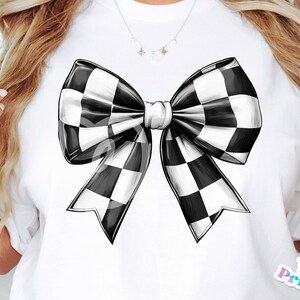 May include: A white t-shirt with a black and white checkered bow drawn on the front. The bow is large and has a center knot.