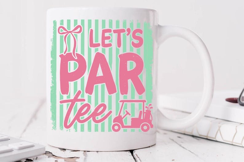 May include: White ceramic mug with the words "LET'S PAR tee" in pink, with a golf cart graphic. The text is set against a mint green striped background. A bow graphic is above the word "PAR".