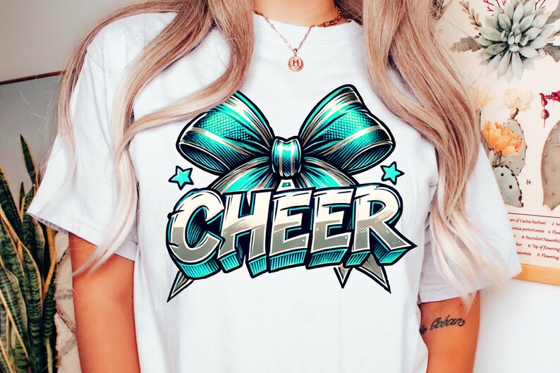 May include: White t-shirt with a blue and gold bow and the word "CHEER" in a stylized font.