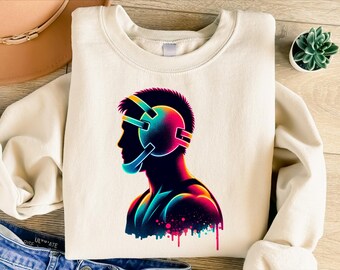 Può includere: Felpa color crema con grafica neon di un lottatore di profilo. Il copricapo e il corpo del lottatore sono resi in un gradiente di colori vivaci, con gocce di vernice nella parte inferiore. Il disegno è centrato sul davanti.