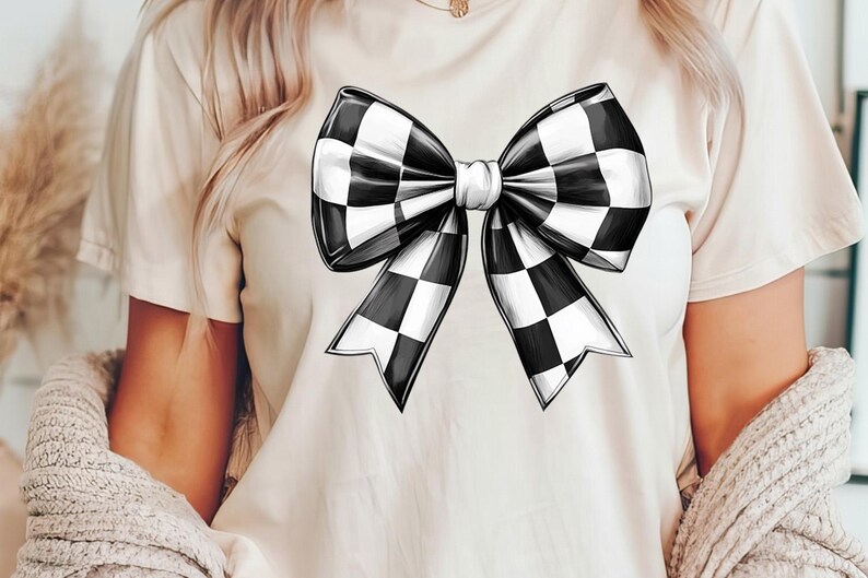 May include: A white t-shirt with a black and white checkered bow design.