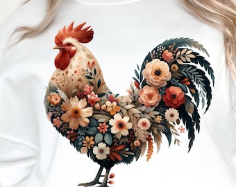 May include: A white sweatshirt with a colorful rooster design. The rooster is made up of flowers and leaves in shades of red, orange, yellow, pink, and green.