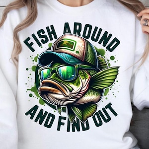 May include: White sweatshirt with a green and black illustration of a fish wearing a hat and sunglasses. The text "Fish Around And Find Out" is printed on the shirt.