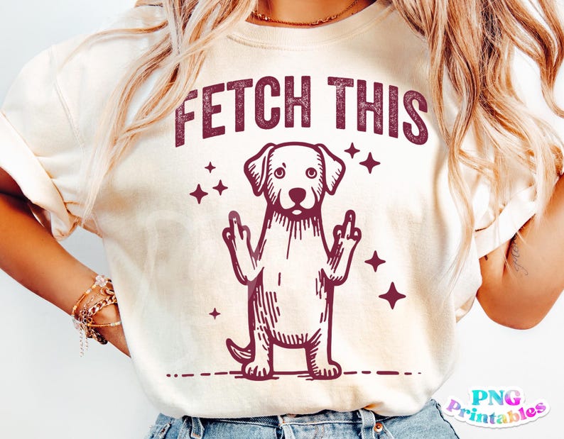 May include: A white t-shirt with a maroon graphic of a dog giving the middle finger with the text "FETCH THIS" above the dog.