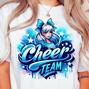 May include: White t-shirt with a blue and white graphic design of a cheerleader with a blue bow in her hair. The graphic says "Cheer Team" in blue and white lettering.