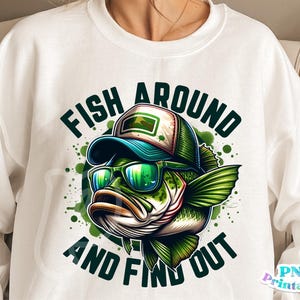 May include: White sweatshirt with a green, black, and white illustration of a fish wearing sunglasses and a hat. The text "Fish Around And Find Out" is printed on the sweatshirt.