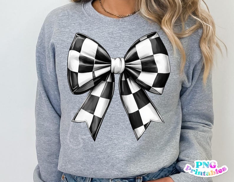 May include: A gray sweatshirt with a black and white checkered bow design.