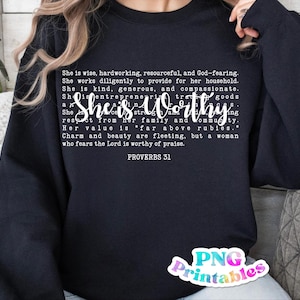 May include: Black sweatshirt with white text that reads "She is wise, hardworking, resourceful, and God-fearing. She works diligently to provide for her household. She is kind, generous, and compassionate. She is entrepreneurial, strong, and a woman of integrity. She is worthy of respect from her family and community. Her value is "far above rubies." Charm and beauty are fleeting, but a woman who fears the Lord is worthy of praise. Proverbs 31."
