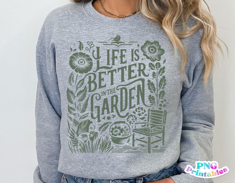 May include: Gray sweatshirt with a green graphic design that says "Life is better in the garden". The graphic includes a bird, flowers, and a chair.