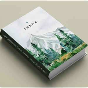 May include: A white book with a watercolor illustration of a snowy mountain range and pine trees. The book's spine is black and the text on the spine reads "Opportunities don't happen, you create them". The front cover of the book has the word "IRENE" printed in black.